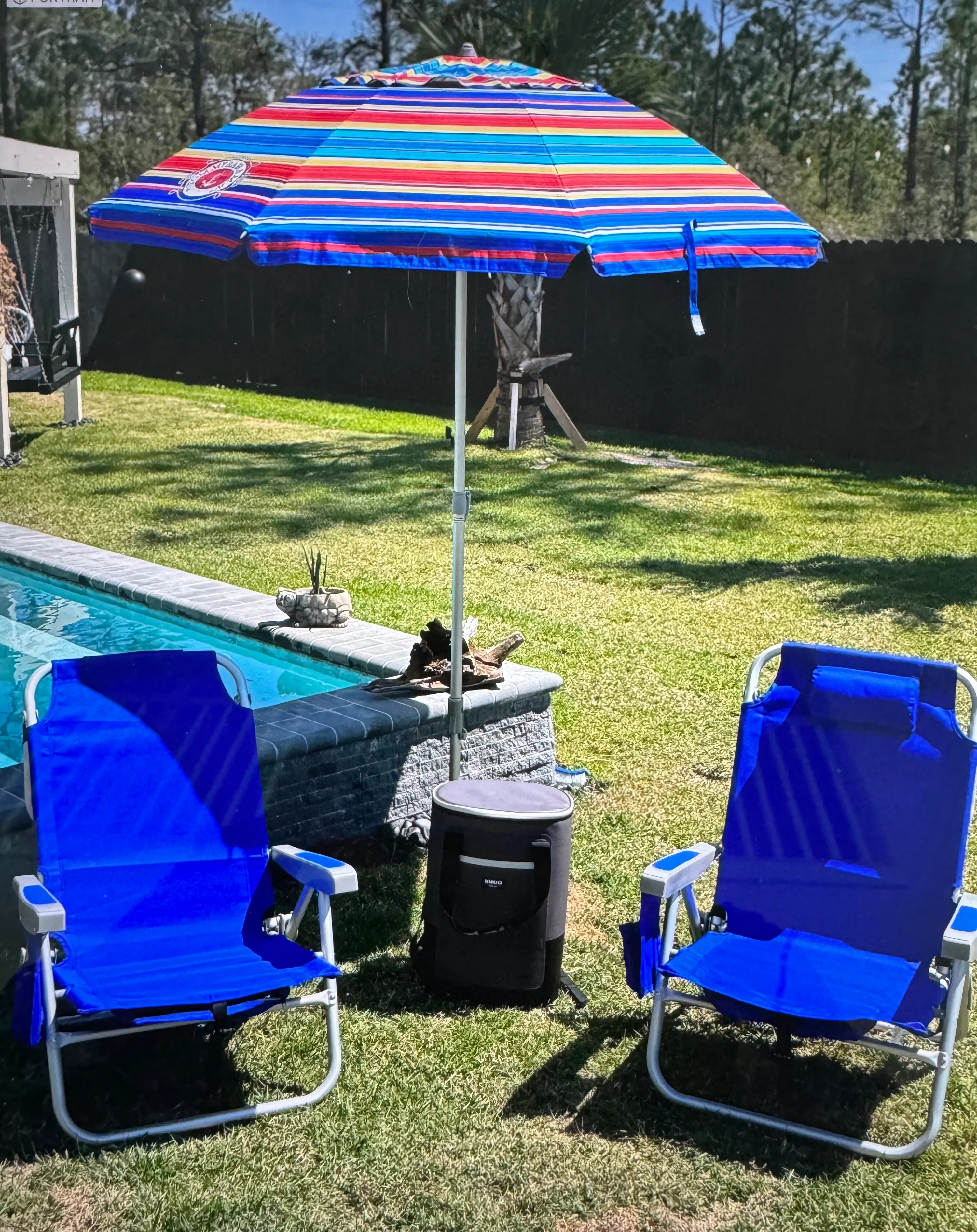2 chairs, umbrella and small cooler