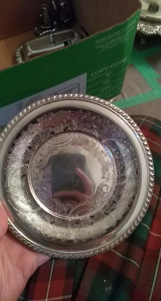 Embossed round polished silver plate with braided edge