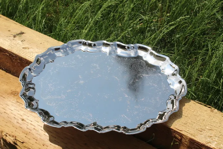 Polished silver oval tray with scalloped edges
